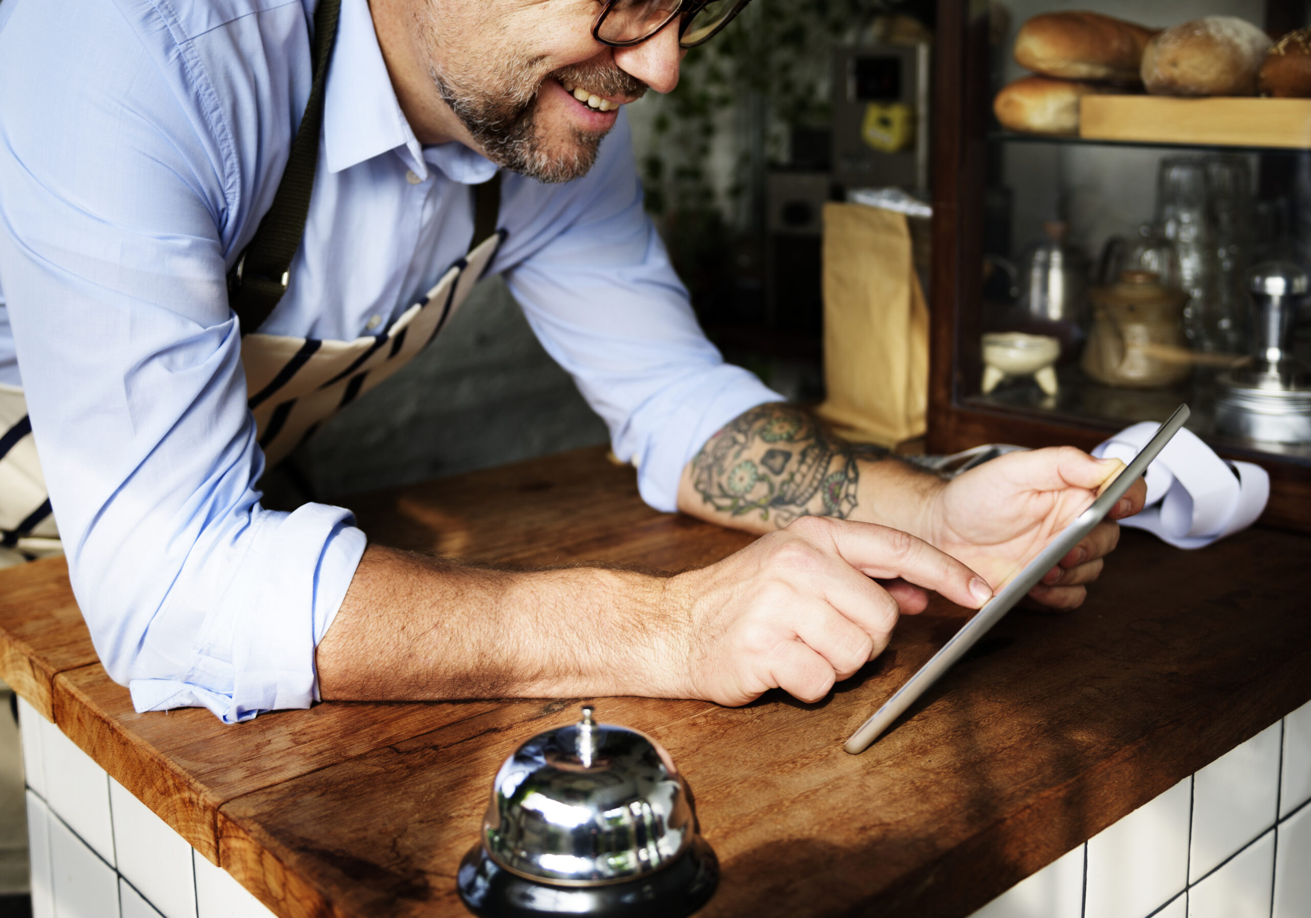 Happy vendor using the loyalty app on his tablet.